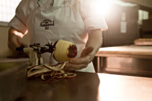 man peeling apple morning light pastry shop food