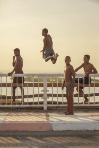 young boys jumping off bridge in egypt nile river