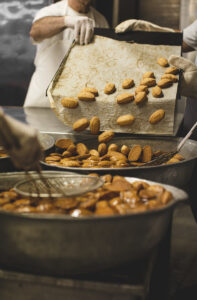 traditional greek pastries melomakarona dipping in syrup christmas