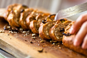 hand grabbing bread cutting knife fresh pastry bakery baking