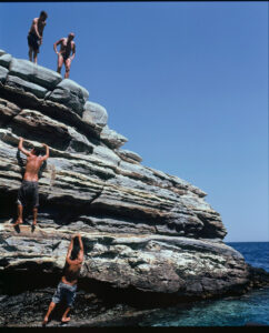 men climbing rocks sea diving greece travel summer blue water ocean